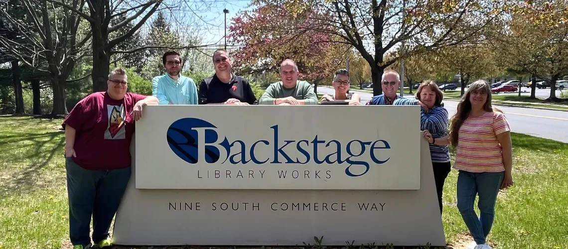 Former MAPS/OCLC employees gather outside around the Backstage sign.